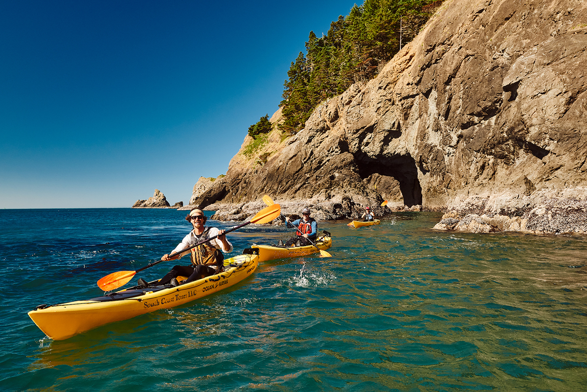 Couple kayaking in Port Orford, Oregon. Photo by Erik Urdahl.