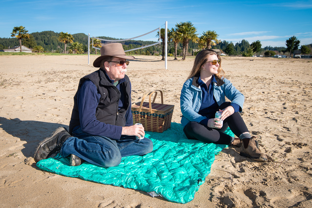 Couple picnicking on Wulfy Beach in Lakeside, Oregon